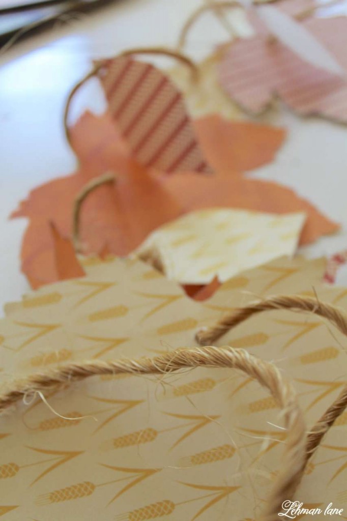 fall cardstock leavesthrough burlap ribbon for a fall mantel