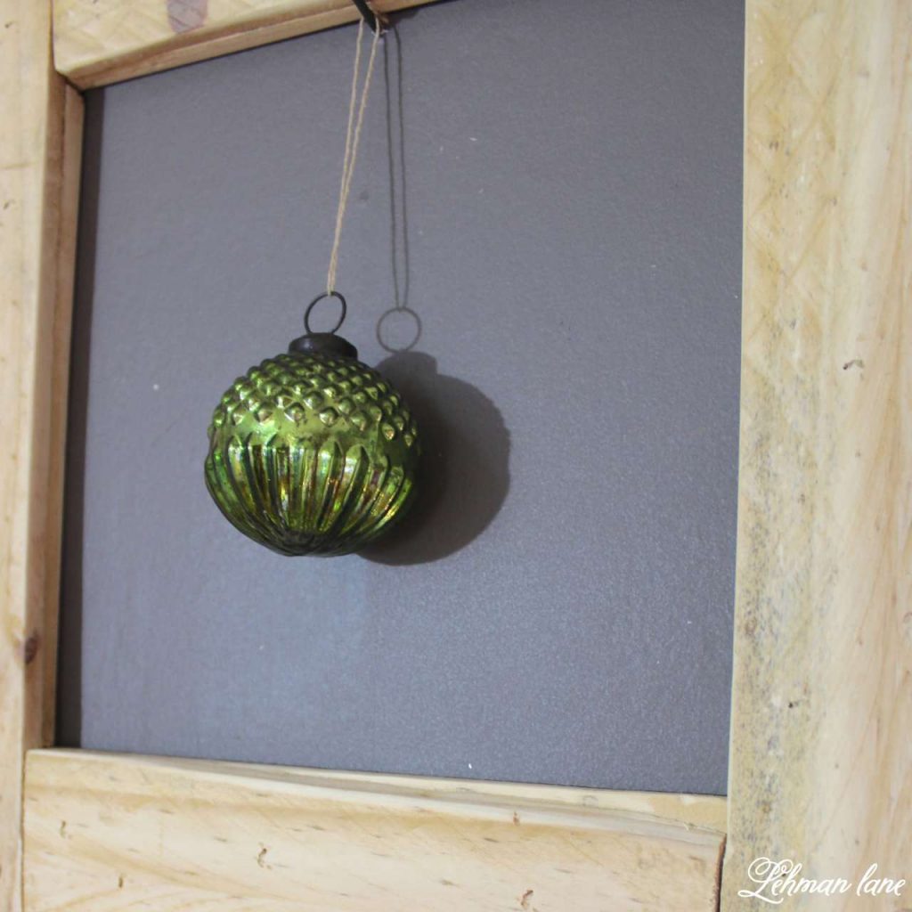 A Very Farmhouse Christmas Home Tour - pallet picture frame and Christmas ball