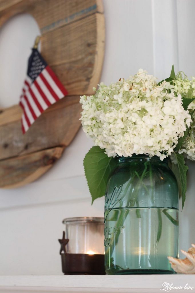 Farmhouse 4th of July Decorating is as simple as you make it. It calls for a collection of vintage & unexpected red, white & blue items from around your home, hydrangeas & of course old glory!   Sharing  ideas of how I decorate our farmhouse for free for the Independence Day! #4thofjuly http://lehmanlane.net