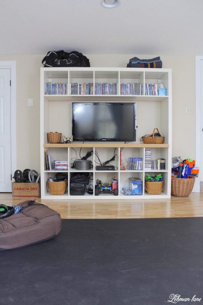 DIY Kallax Ikea Hack - We transformed our Kallax large bookcase from Ikea into a space saving Entertainment stand in just a few hours for our newly renovated home gym.  I am sharing all the details of how we DIYed this Ikea hack for only a few dollars #ikeahack  #diy https://lehmanlane.net