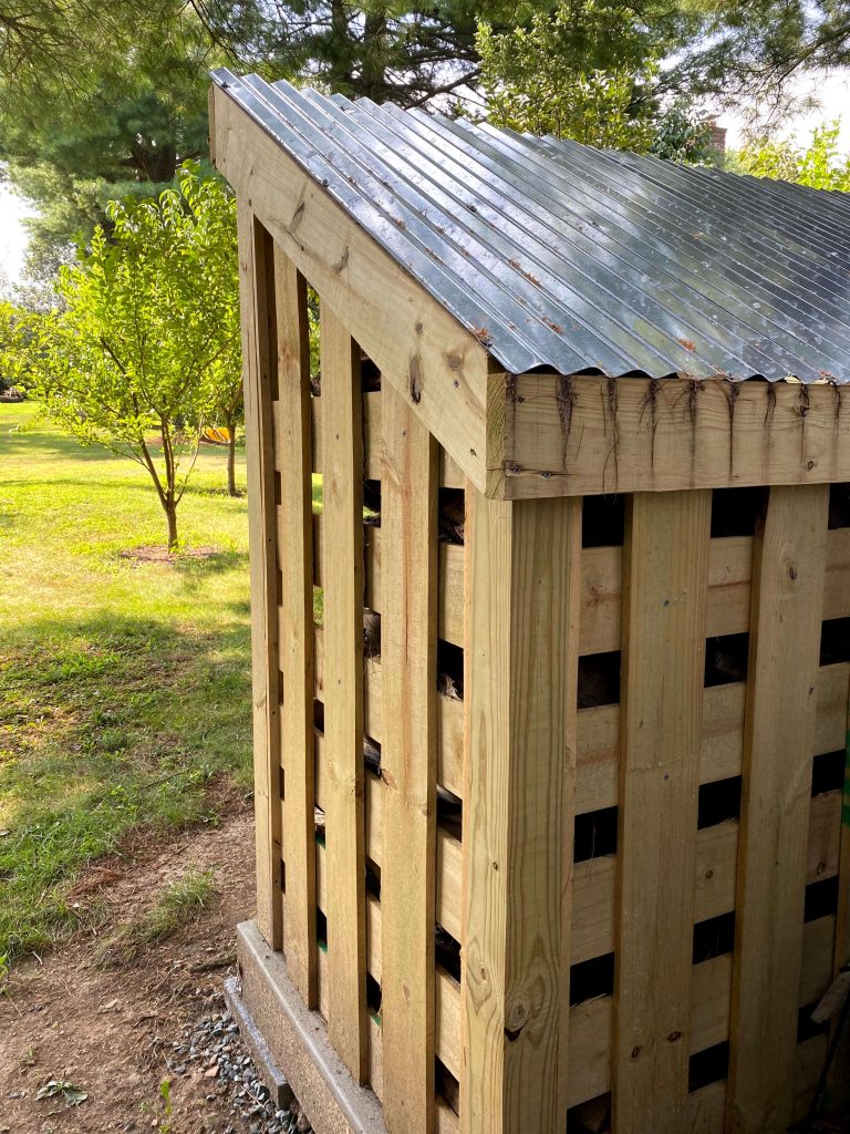 Sharing all our tips & tricks for building a large DIY outdoor wood firewood storage shed on a budget that looks nice in the backyard with step by step instructions for How to build a firewood storage shed for wood log storage with pictures! #firewoodstorage #storageshed https://lehmanlane.net