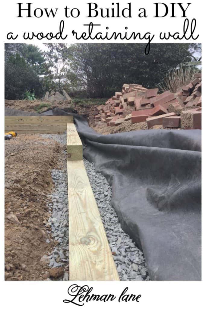 Sharing all our tips & tricks for how to build an awesome and easy DIY wood retaining wall with step by step instructions and pictures. #woodretainingwall #outdoordiyprojects #patioproject https://lehmanlane.net