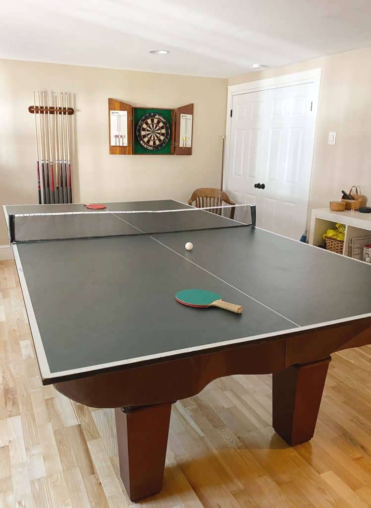 Sharing all of our tips and tricks for how we created this awesome and easy DIY ping pong table top storage for less than $25 with pictures.  Our DIY ping pong table top has become a focal point of our basement wall and takes up ZERO floor space!!! #gameroom #pingpongtabletop https://lehmanlane.net