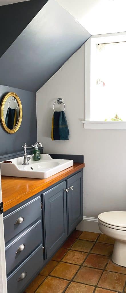 Sharing all my tips and tricks for how I transformed our farmhouse powder room into a stunning and moody half bath with Benjamin Moore's anchor gray paint in just one day with pictures. #moodybathroomideas #paintingprojects https://lehmanlane.net