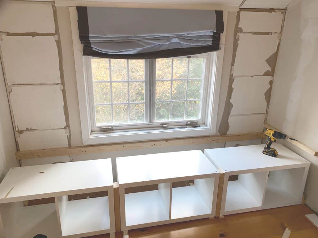 Sharing all our tips and tricks of how we made this easy and awesome DIY Window Seat using a Ikea Kallax Hack Bookshelf as a Bench with step by step pictures. We made the Kallax window seat large enough so it could double as a bed for overnight guests with bookcases underneath to provide extra storage.